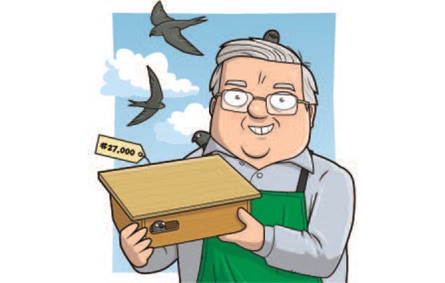 swift nest boxes | john holds up his 27000th nest box as swifts fly past behind him